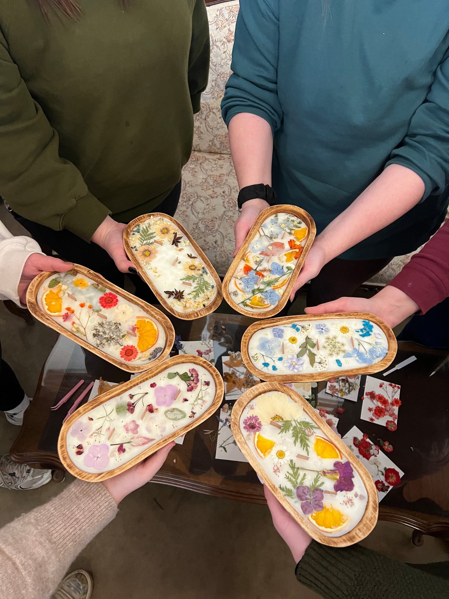 A group of friends share their creations of wood bowl candles