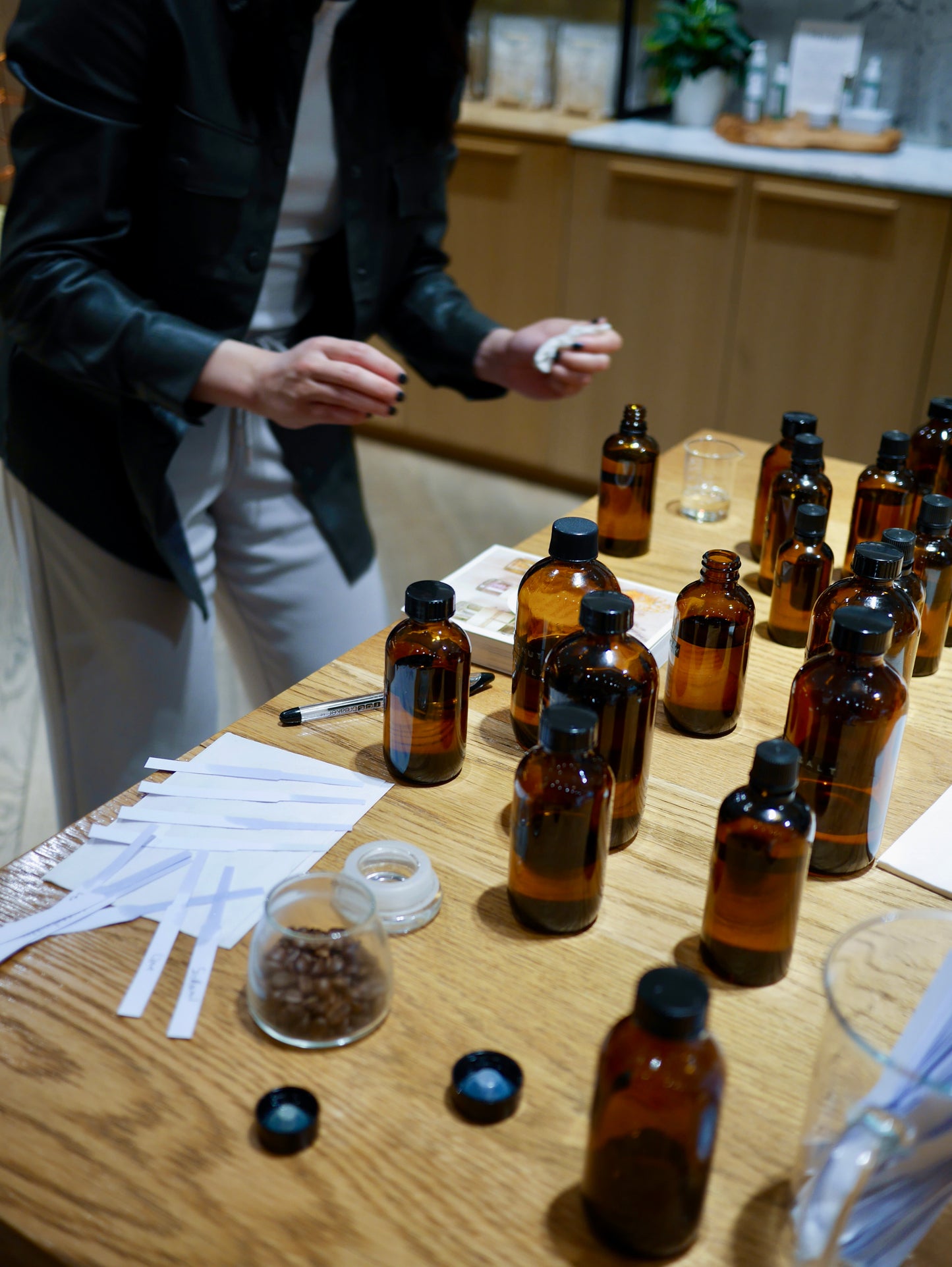 Participant is testing different scents in amber glass bottles